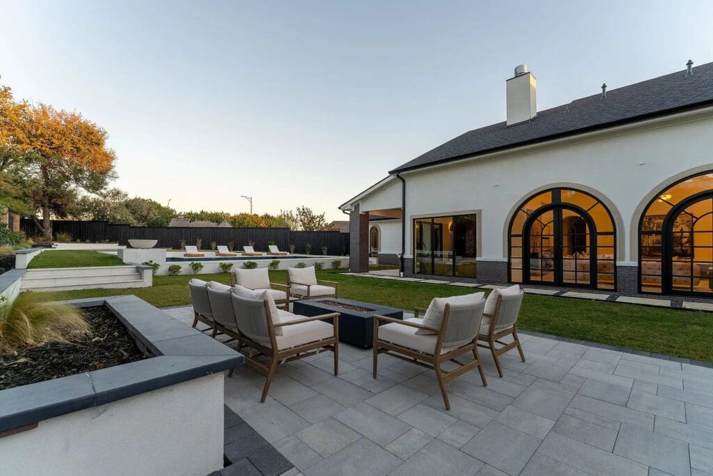 The resort-style backyard features multiple seating areas. (Photo by Compass RE Texas, LLC)