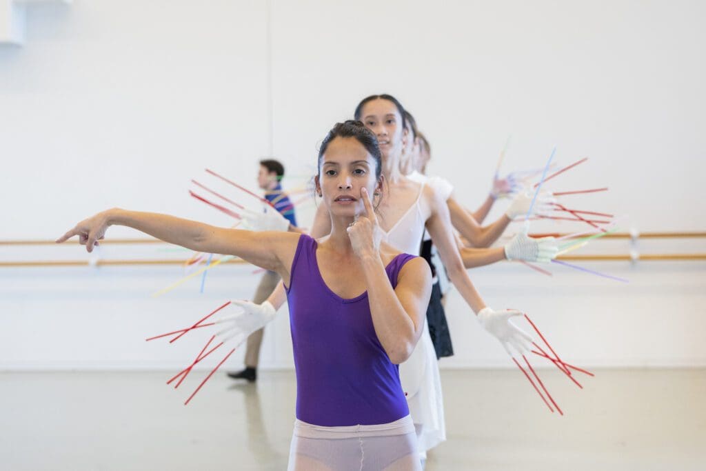 Houston Ballet principal Karina González as Frida Kahlo with artists of Houston Ballet rehearse Annabelle Lopez Ochoa’s “Broken Wings.” (Photo by Alana Campbell, 2026. Courtesy Houston Ballet.)