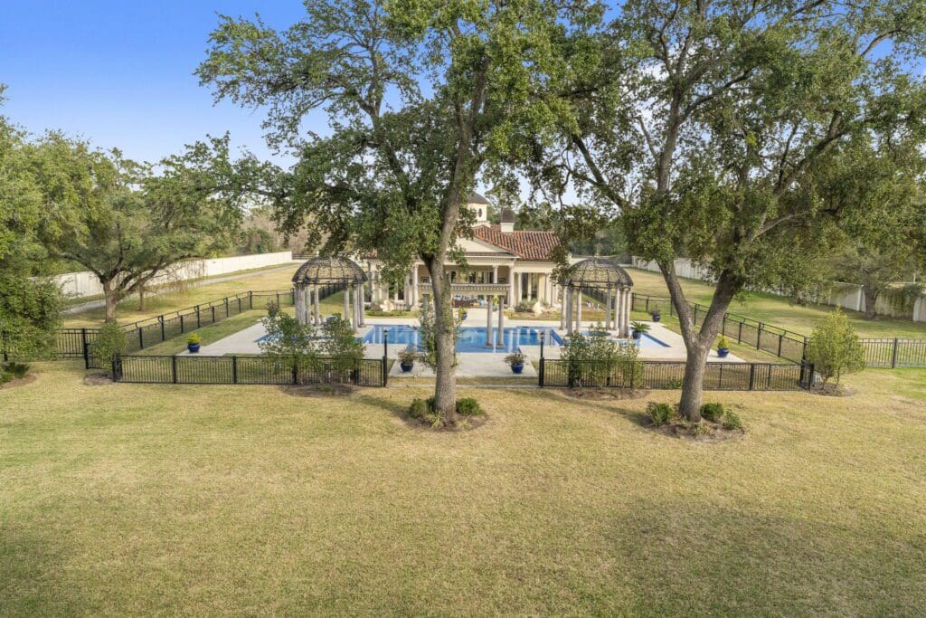 The gated pool and lavish pool house at 6 W. Rivercrest Drive (Photo by Iconic Images)