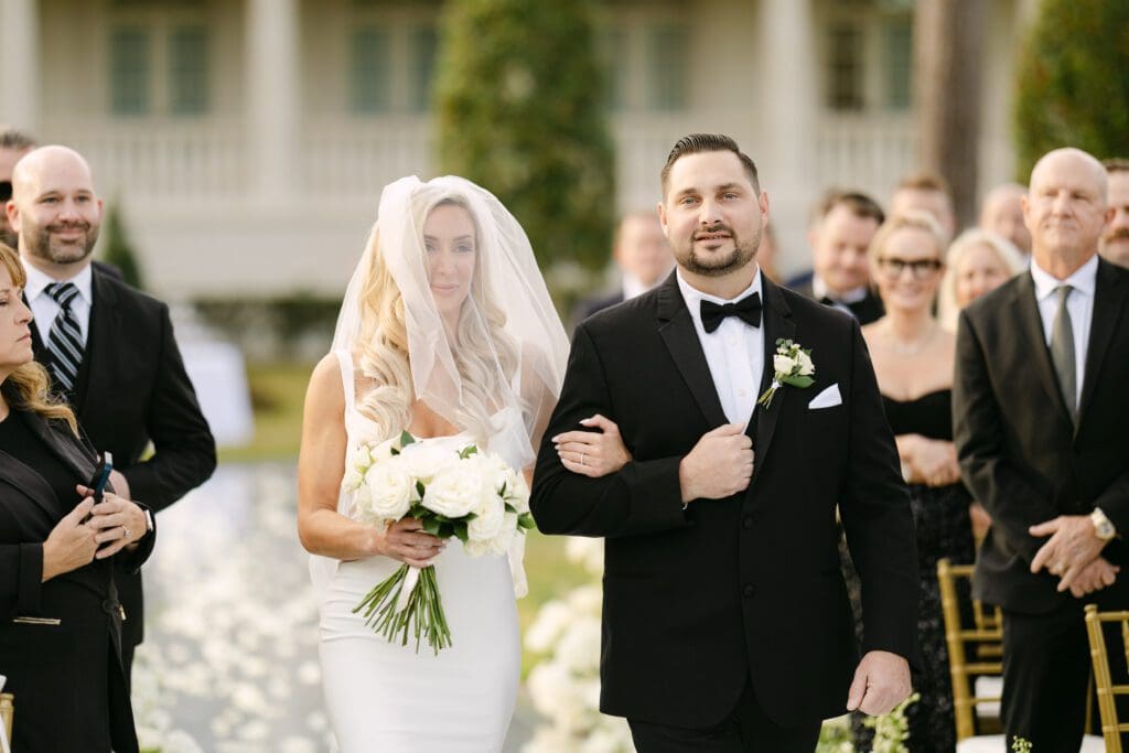 Claudine was escorted down the aisle by her twin brother Claude. (Photo by Weddings by Trey)