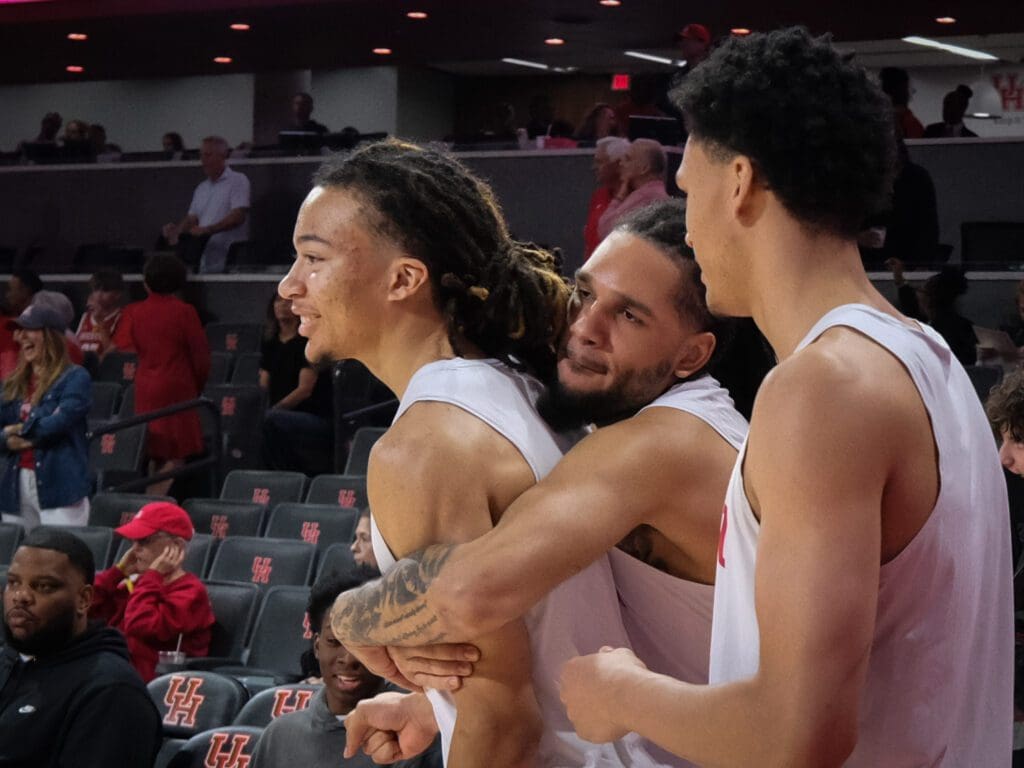 University of Houston poiint guard Kingston Flemings gets a hug from veteran guard Emanuel Sharp. (Photo by F. Carter Smith) 
