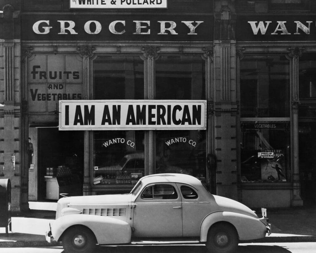 Dorothea Lange, “Oakland, California, March 1942 – A large sign reading, ‘I am an American’ placed in the window of a store in Downtown Oakland on December 8, the day after Pearl Harbor. The store was closed following orders to persons of Japanese descent to vacate from West Coast areas. The owner, a University of California graduate, will be
relocated with hundreds of Japanese-Americans to a War Relocation Authority center,” 1942, at FotoFest (Courtesy of the Library of Congress, Washington, DC)