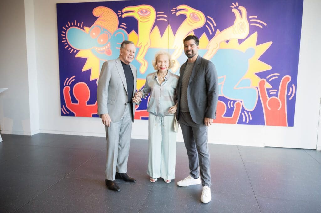 Richard Flowers, Lynn Wyatt, Angel Rios at the Collector's preview of Opera Gallery in River Oaks District, pictured in front of a work by Keith Haring (Photo by Daniel Ortiz)