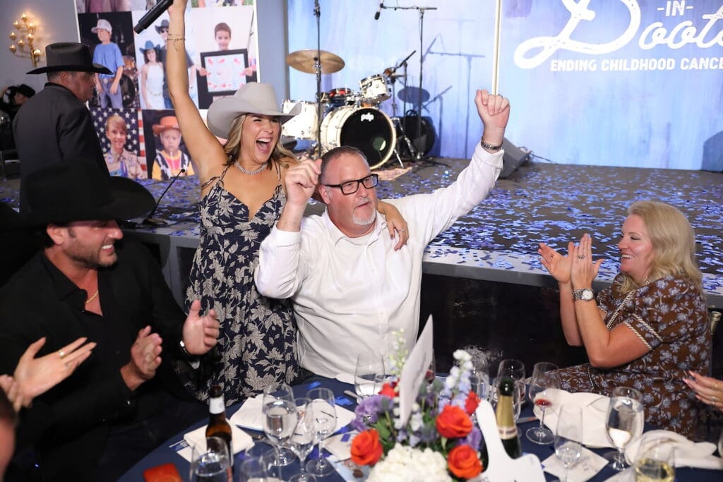 Brittany Franklin and Strider Noone, Senior Sales Manager with JD Fields & Company, wins the Villa in Cabo donated by Matt Hubbard for $175,000 on behalf of JD Fields & Company (Photo by Quy Tran) Photography