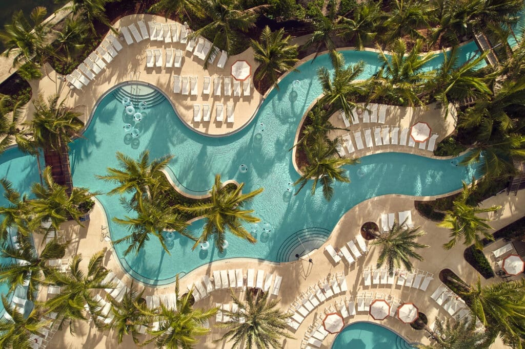 Harborside Pool Club offers guests three pools, a 450-foot lazy river, two water slides, luxury cabanas with personal butler service, and a Pool Bar.  (Photo by The Boca Raton)