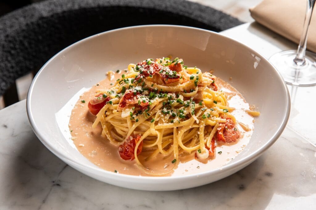 The lobster pasta ($58) is linguine tangled with butter-poached lobster claw meat in a white wine garlic sauce. Photo by Madelynne Grace.