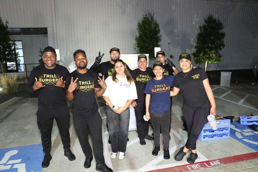 The Trill Burger Team delivering end of night burgers for the departing crowd at the Sky High for Kids 'Better in Boots' gala (Photo by Quy Tran Photography)
