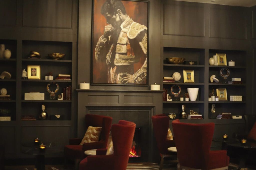Dark wood paneling, dim lighting, portraits of matadors, and red decor throughout lend House of Toro a warm, Old World sensibility. (Photo by House of Toro )