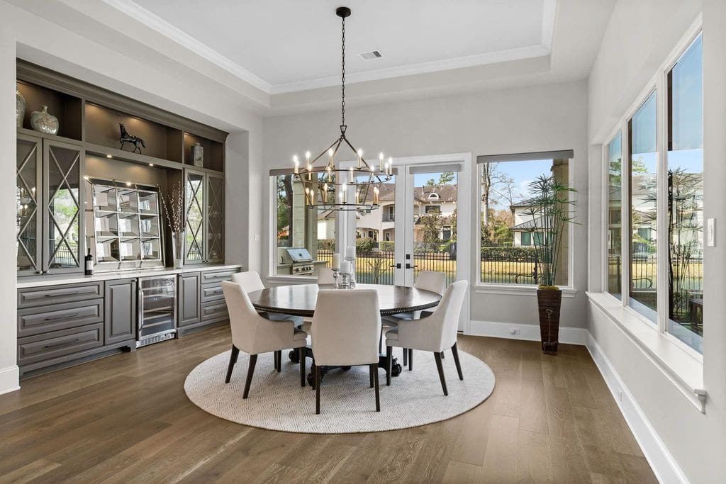 Surrounding wall windows highlight the stunning dining room in this Carlton Woods home.