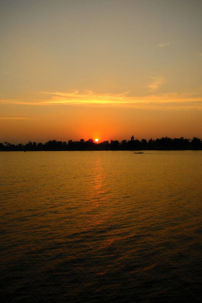 Sundowner cocktails on quiet stretches of riverbank are a ritual of the Aqua Mekong expedition. (photo by Georgie Miller)