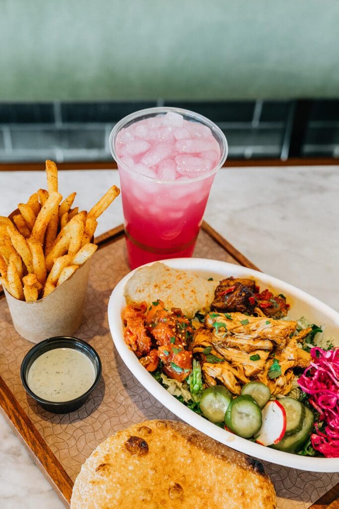 The feast begins with a choice. Choose a salad ($10.90), a sandwich ($8.90), or a hummus plate ($9.90) and then pick hummus or baba, a crunchy addition like crispy onions or pita chips, your protein if desired (+$2 to $5 extra), then load up with pickles from sweet beets to cucumbers to cabbage, drizzle a sauce like z’hug with jalapeno and cilantro or tahini dressing and top with more veggies like cauliflower, eggplant, or carrots. (Photo courtesy of Brassica) (Photo by Photos courtesy of Brassica)