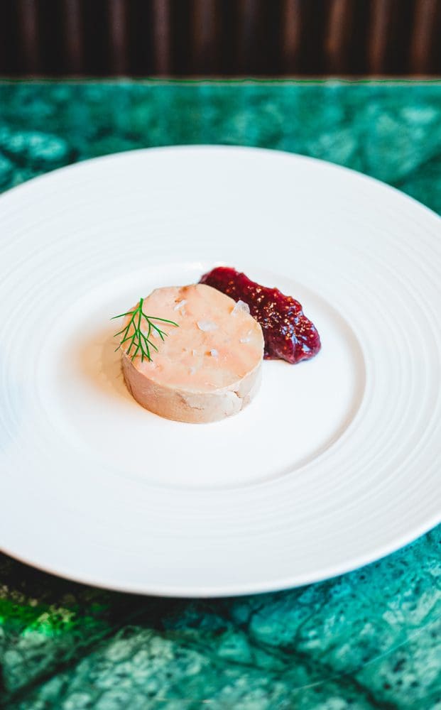 Foie gras torchon atop crostini with a fig preserve is an Osteria di Mercato.