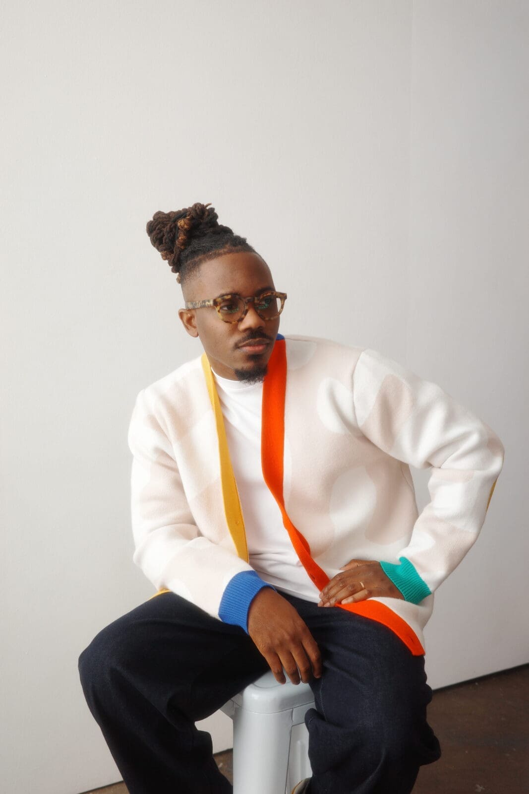 2018 Adobe Creative Resident Temi Coker sports a wool cardigan from his fashion collection.