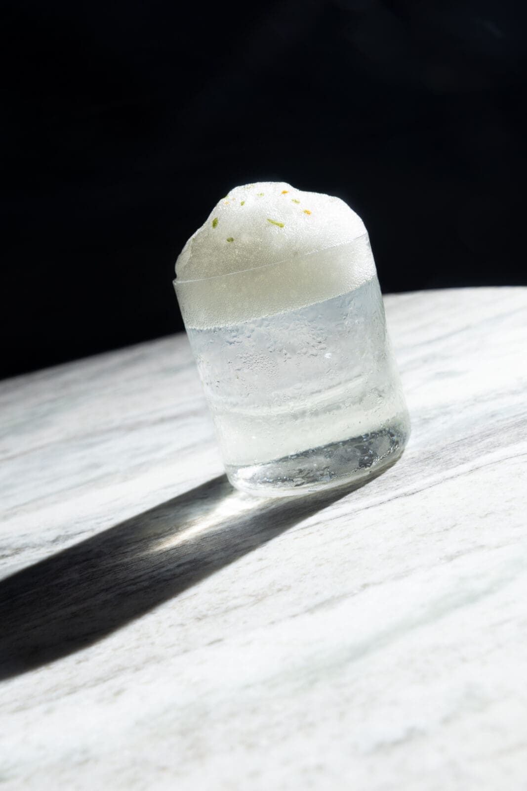 Their signature 1111 Margarita is made with tequila infused with fresh tangerines, followed by a clarification process, to create a bright citrus profile with a smooth, crystal-clear finish. Instead of a traditional salt rim, the drink is topped with a lime-salted air (with an appearance like airy sea foam washing up on the shore). Photo by Josh Aranda.