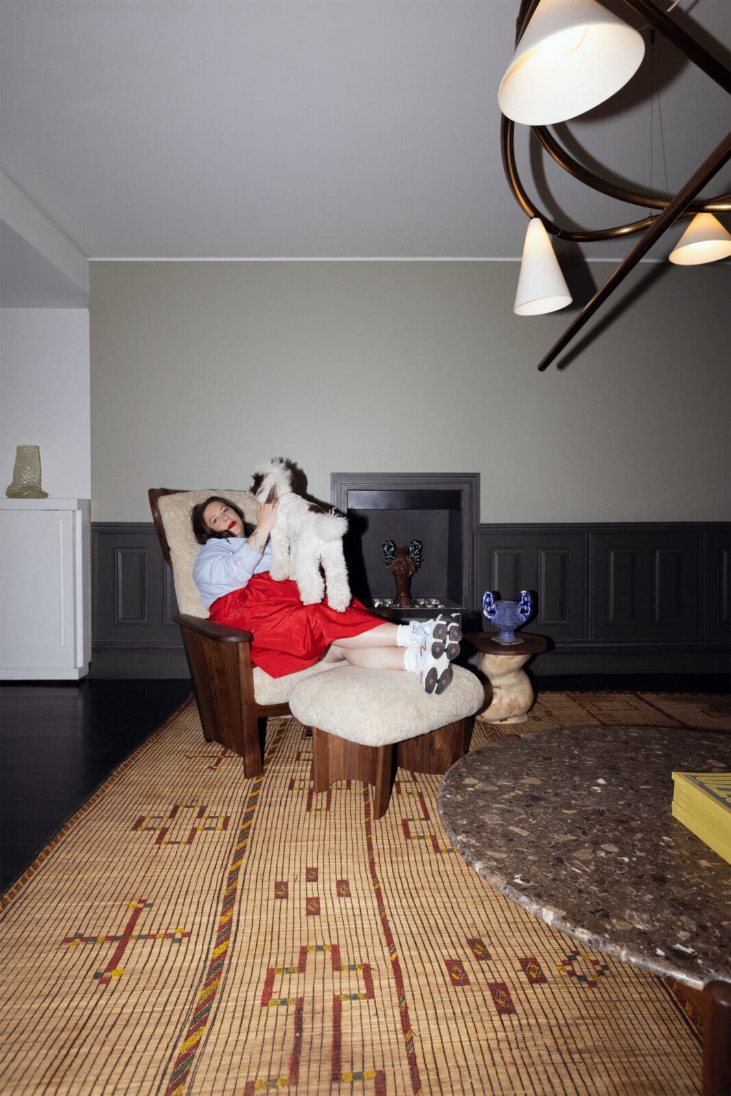 Laura Young, pictured with Sketch Light Large – Sulfur Bronze by Anna Karlin; Twenty-Five Bergère Chair – Danish Oiled Walnut + Curly Sheepskin Mohawi and Twenty-Five Coffee Table by De La Espada; Side table and vessel by Rafi Ajl; and Bubble Handle Vase – Lilac by Natalia Triantafylli. Available exclusively at The Future Perfect. (Photo by David Sierra)