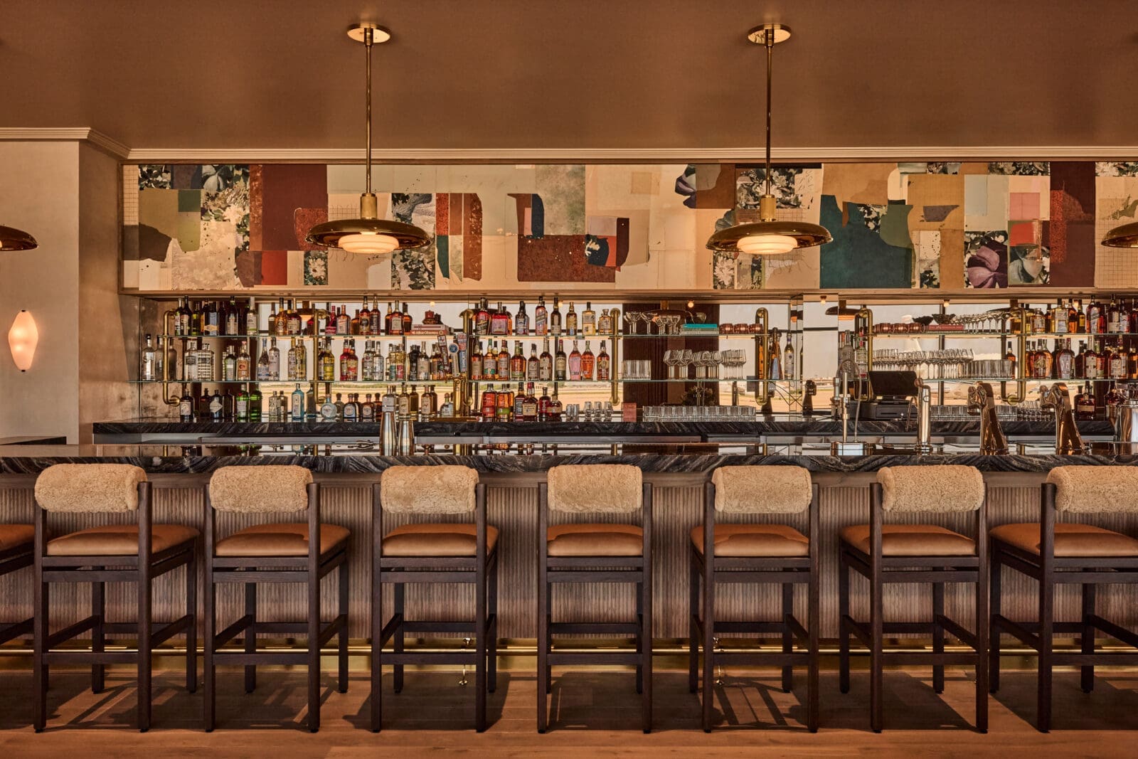 In The Salon, a 40-foot bar is a monumental ode to old-fashioned bars in the South, intended to be a true social gathering place and a spot to unwind before or after traveling. (Photo by Jenna Peffley)