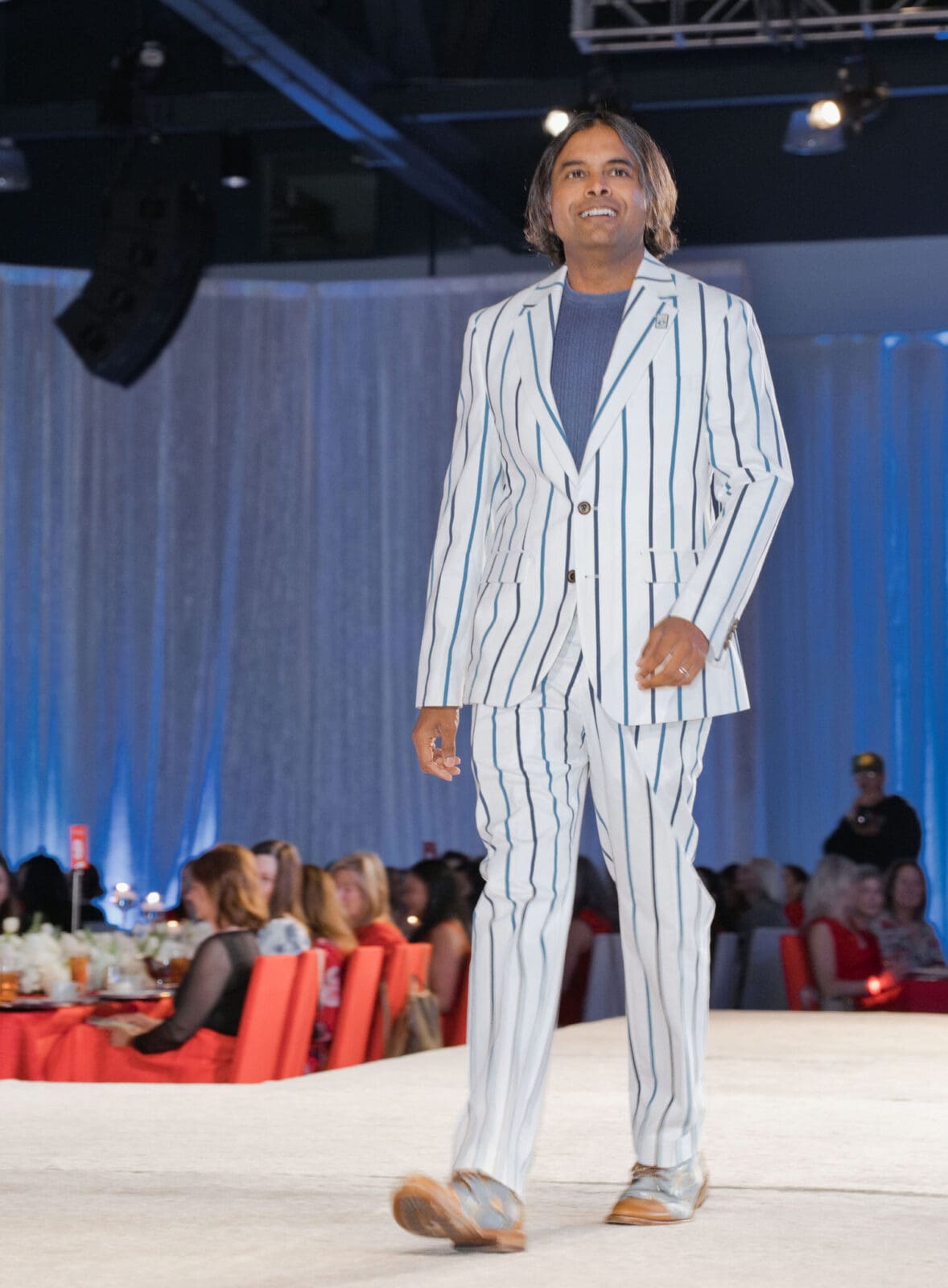 Dr. Paulraj Samuel modeled fashions on the runway during the Go Red for Women Luncheon at The Woodlands Waterway Marriott. (Photo by 209 Photobooth)