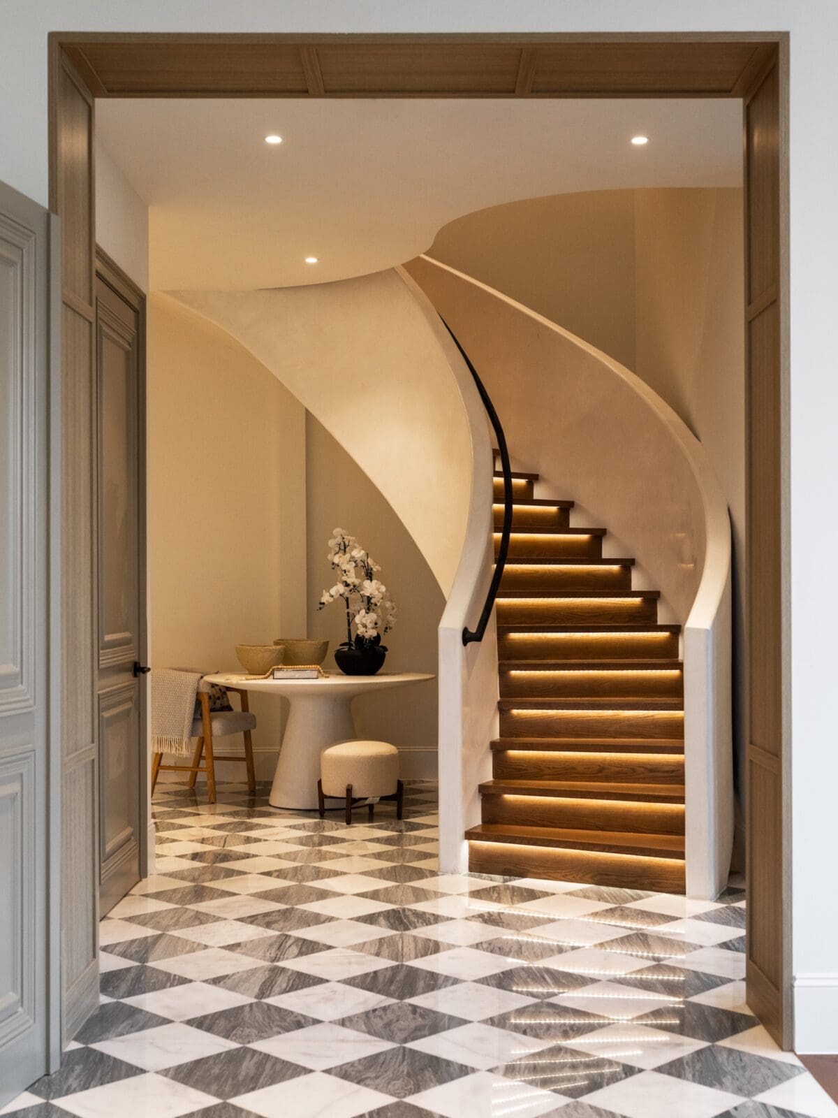 The  sculptural floating staircase,sets the elegant tone for the Belfiore penthouse (Photo by Harry Stonhill)