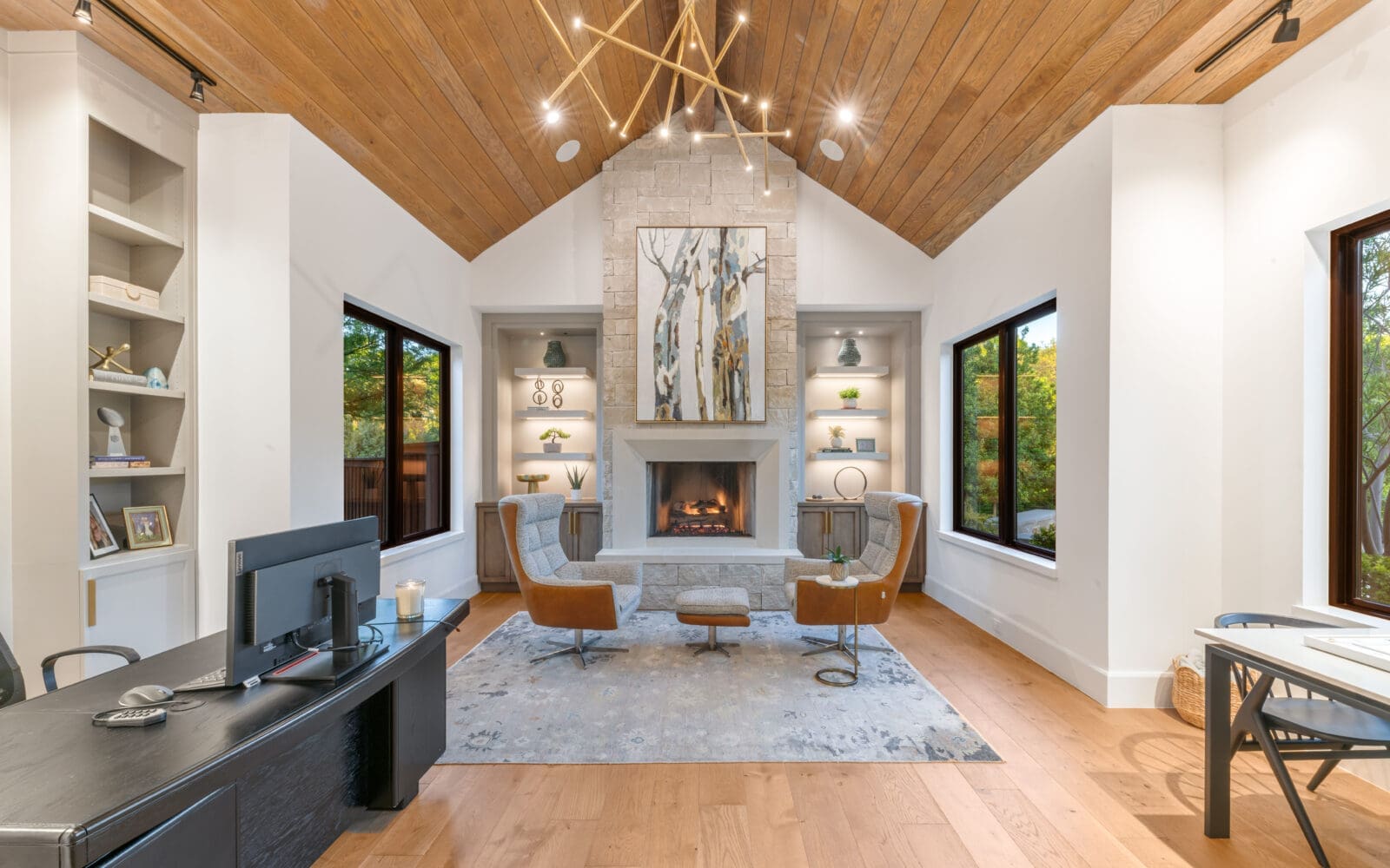 The soaring ceilings and abundance of glass capitalize on natural light and blur the separation between interior living and the verdant landscape beyond it. (Photo by Costa Christ / Compass)