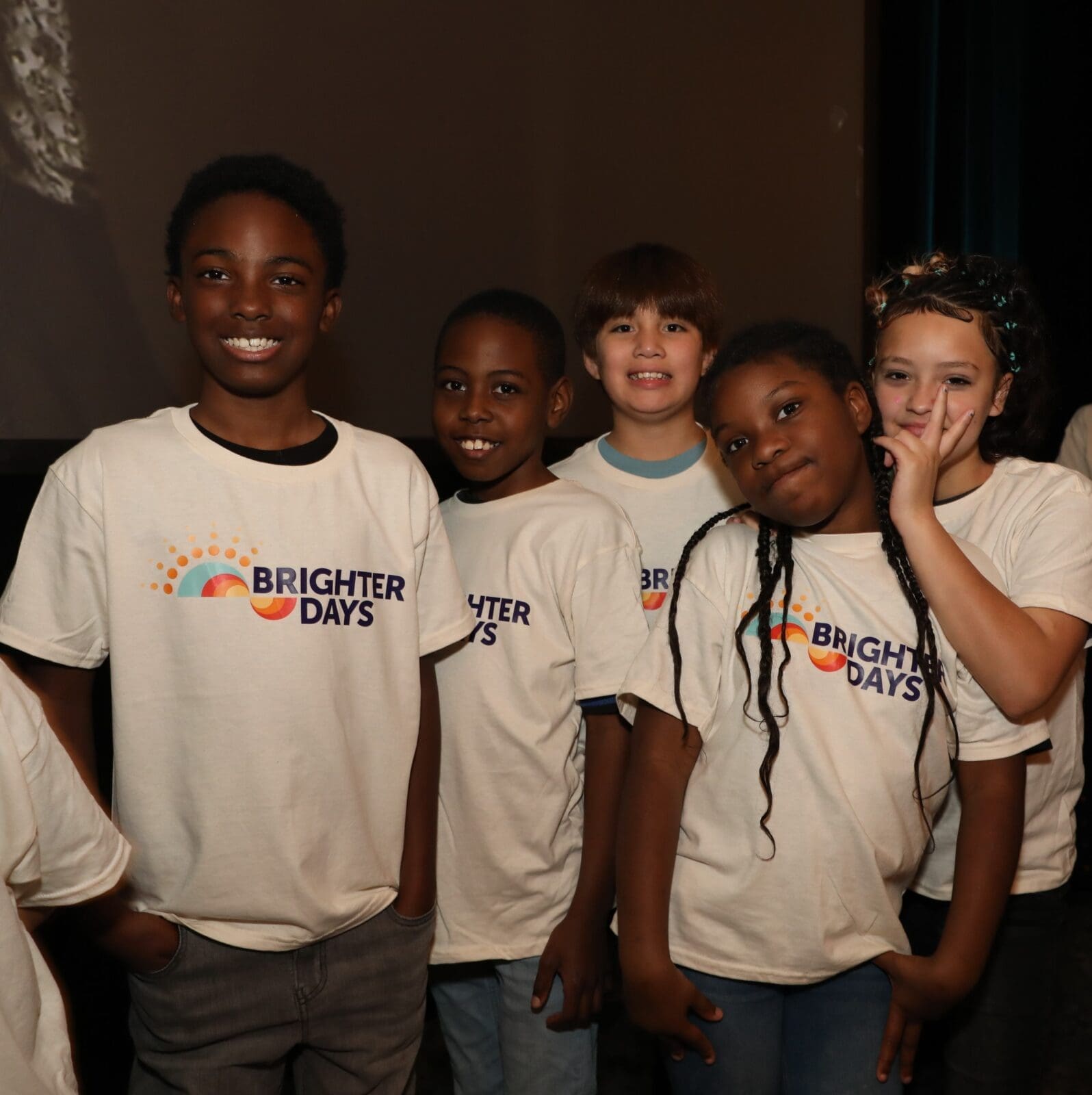 Brighter Days participants with the organization's new name and logo (Photo by Thomas Garza and Rob Wythe/Wythe Portrait Studio)