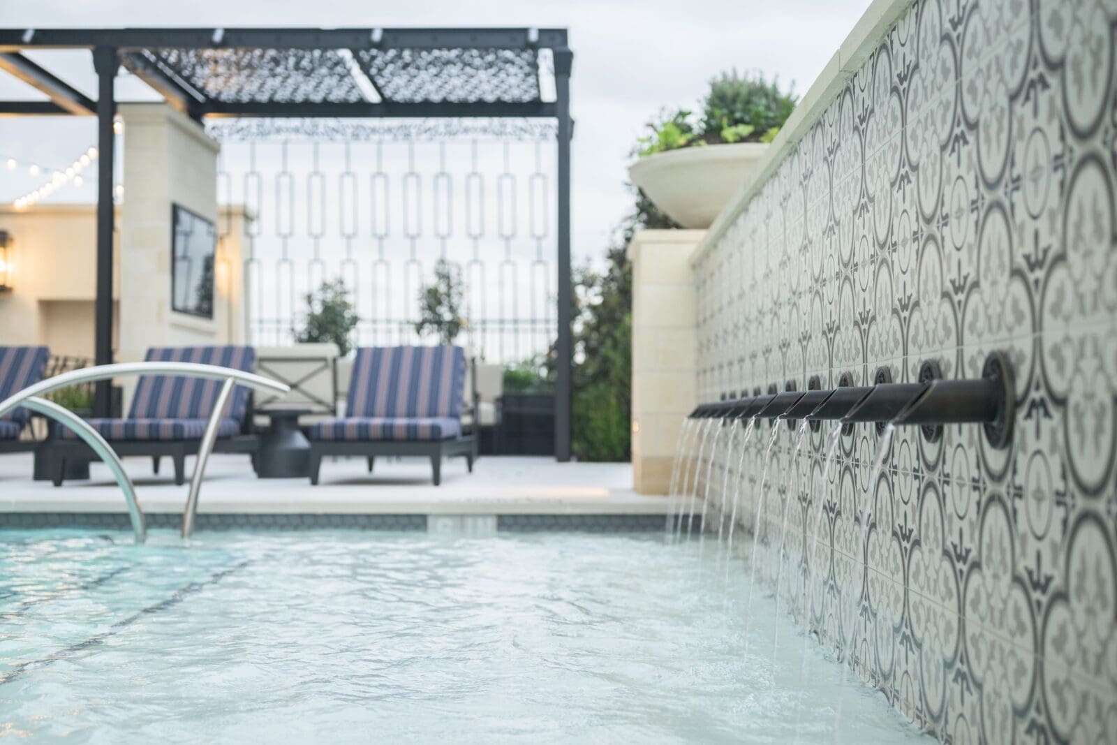 A fountain wall adds a point of interest to the pool at The Langley.