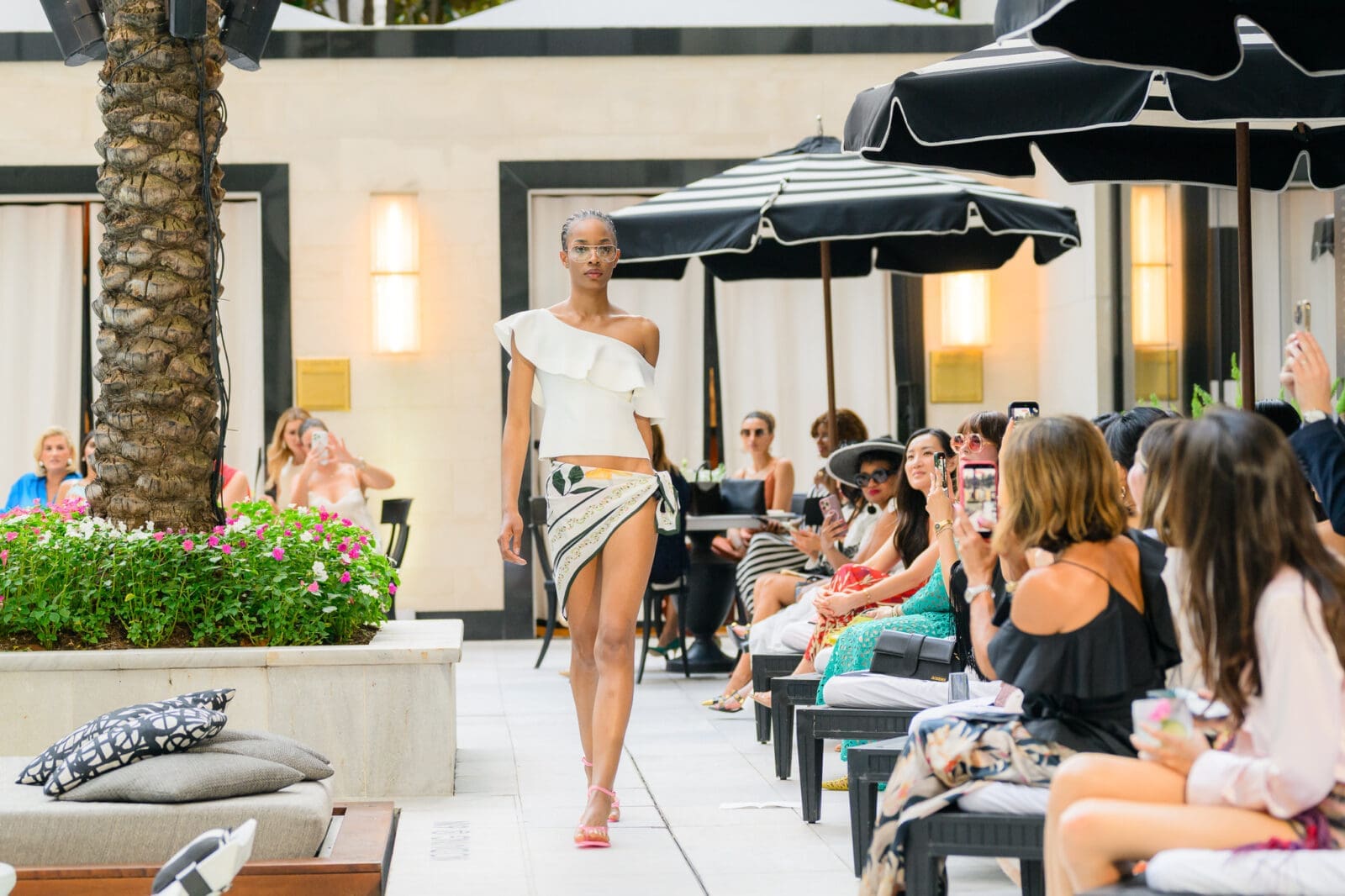 A sexy moment in the Christy Lynn 2026 High Summer fashion presentation poolside at the Post Oak Hotel. (Photo by Si Vo)
