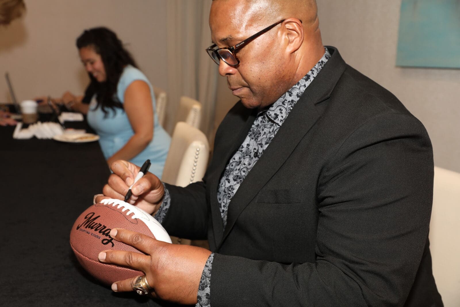 Keith Davis, a former Dallas Cowboys player, signed footballs (Photo by Thomas Garza and Rob Wythe/Wythe Portrait Studio)
