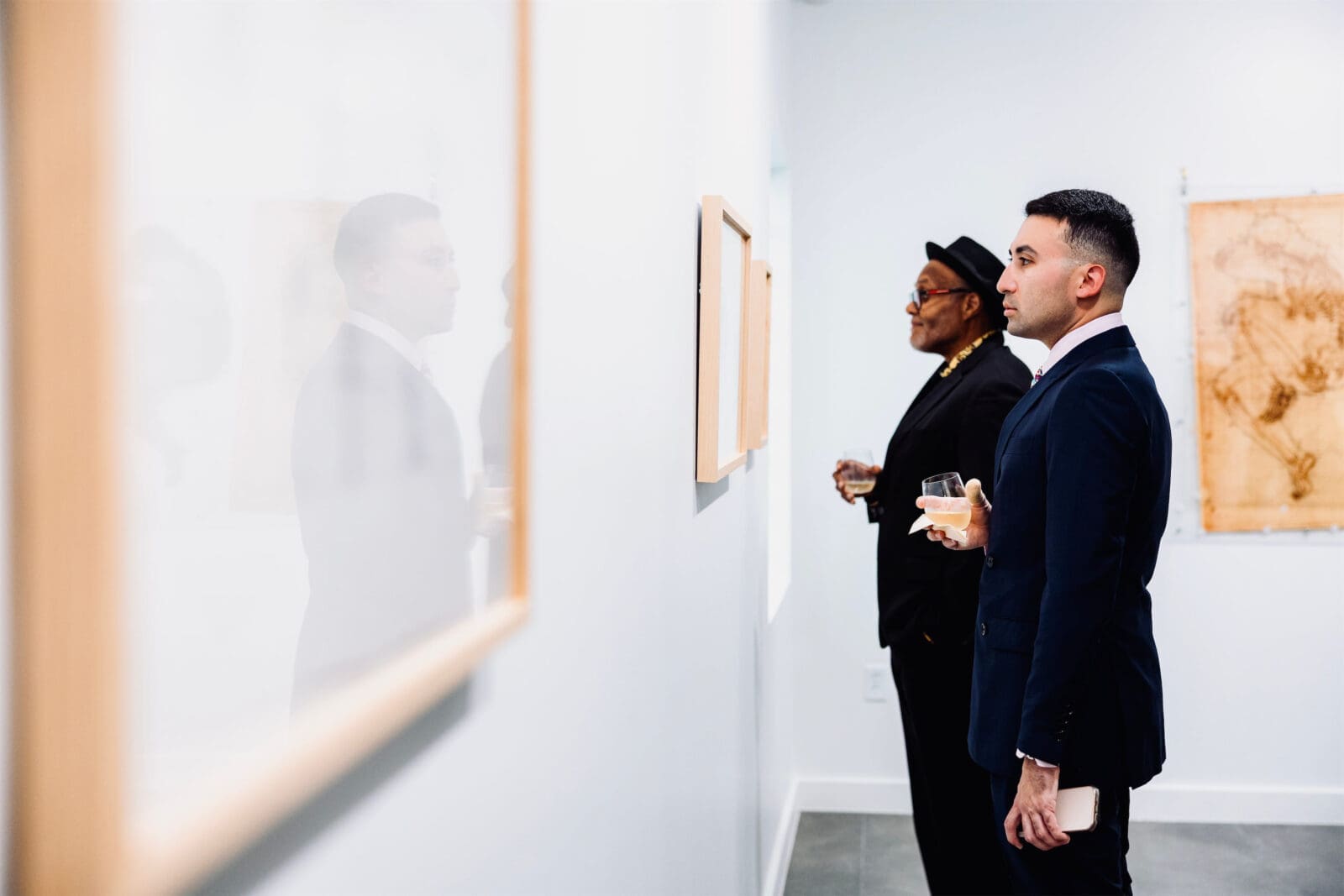 Stephen M. Miranda (foreground) and Daryl Basham (background) take in Mel Chin's "Living Score" at the Houston Arts Alliance Gilded & Golden Kickoff (Photo by Hung L. Truong)