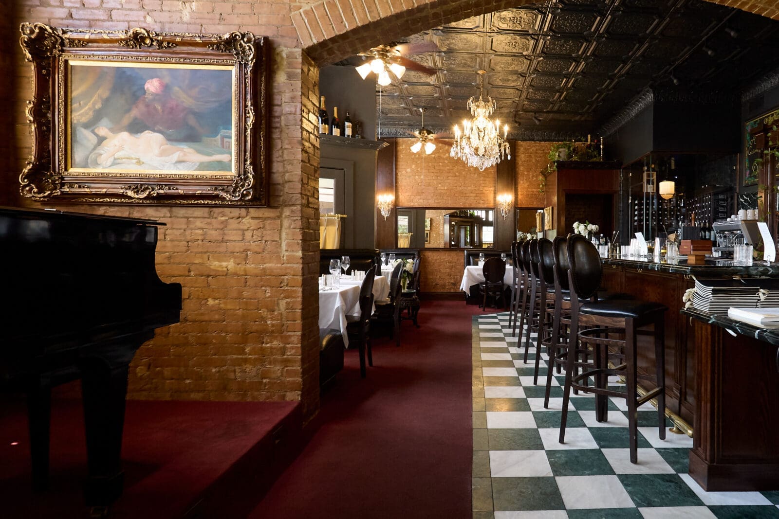 The new St. Martin's space features black-and-white checkerboard floors, chandeliers, and a piano — retaining the classic charm of the original while offering a refreshed feel. (Courtesy)