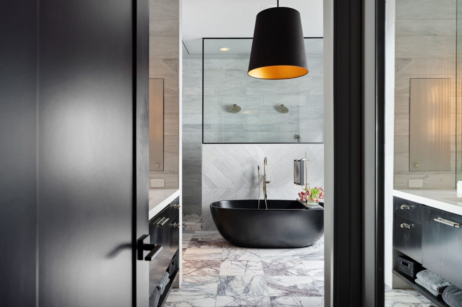 The primary bath unfolds with a sculptural soaking tub, expansive walk-in shower, and dual vanities.  (Photo by Aria Media)