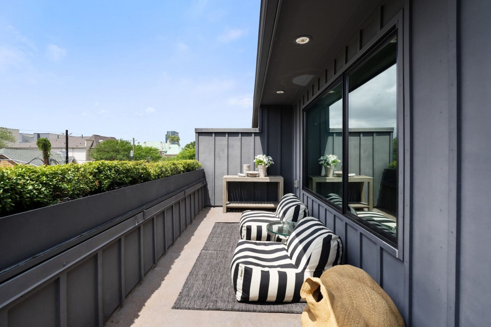 The rooftop terrace offers views across the tree-shrouded neighborhood. (Photo by Aria Media)