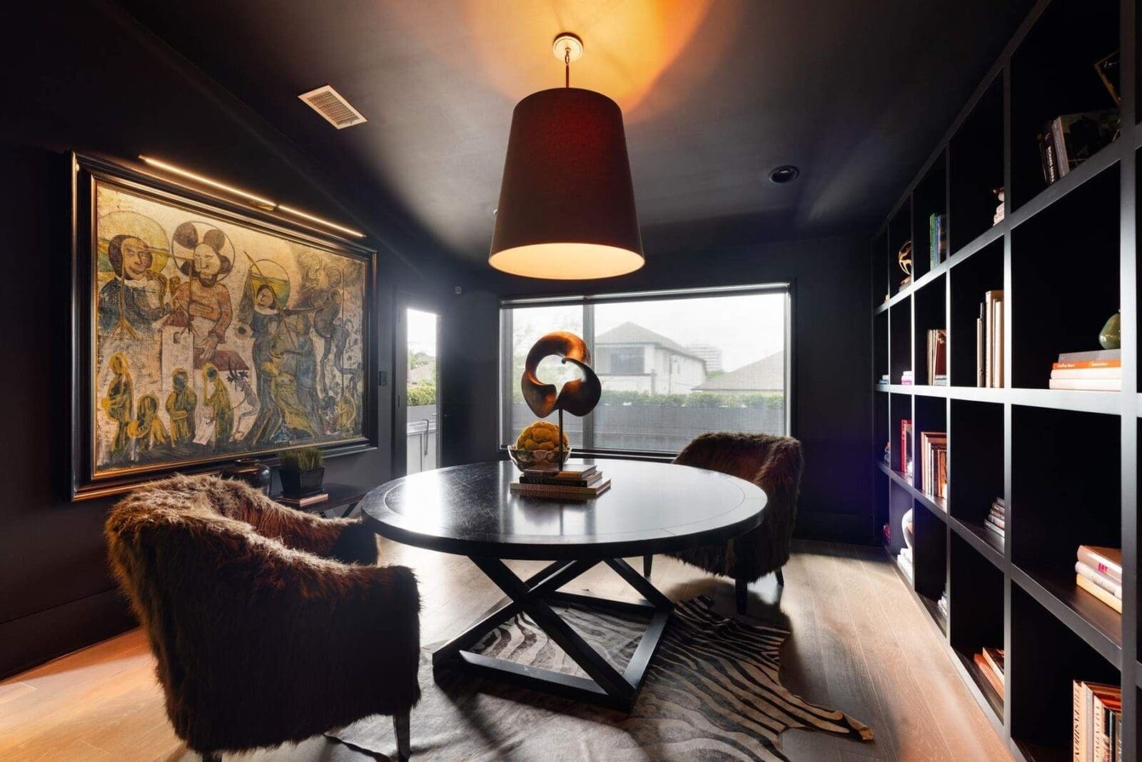 Custom built-ins define this third-floor living space, currently styled as a library.  (Photo by Aria Media)