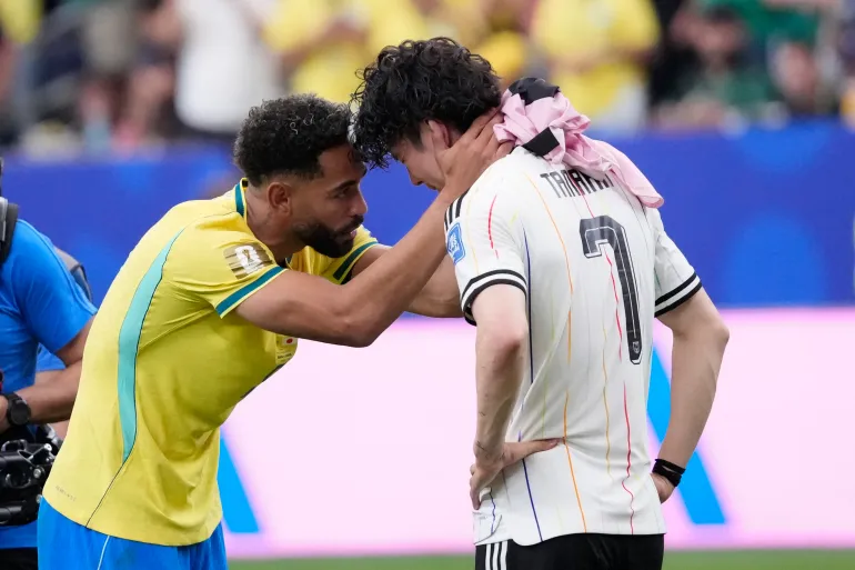 Brazil's Matheus Cunha took the time to try and comfort a distraught Japan player Ao Tanaka after Brazil's stunning end of stoppage time goal eliminated Japan from the World Cup.