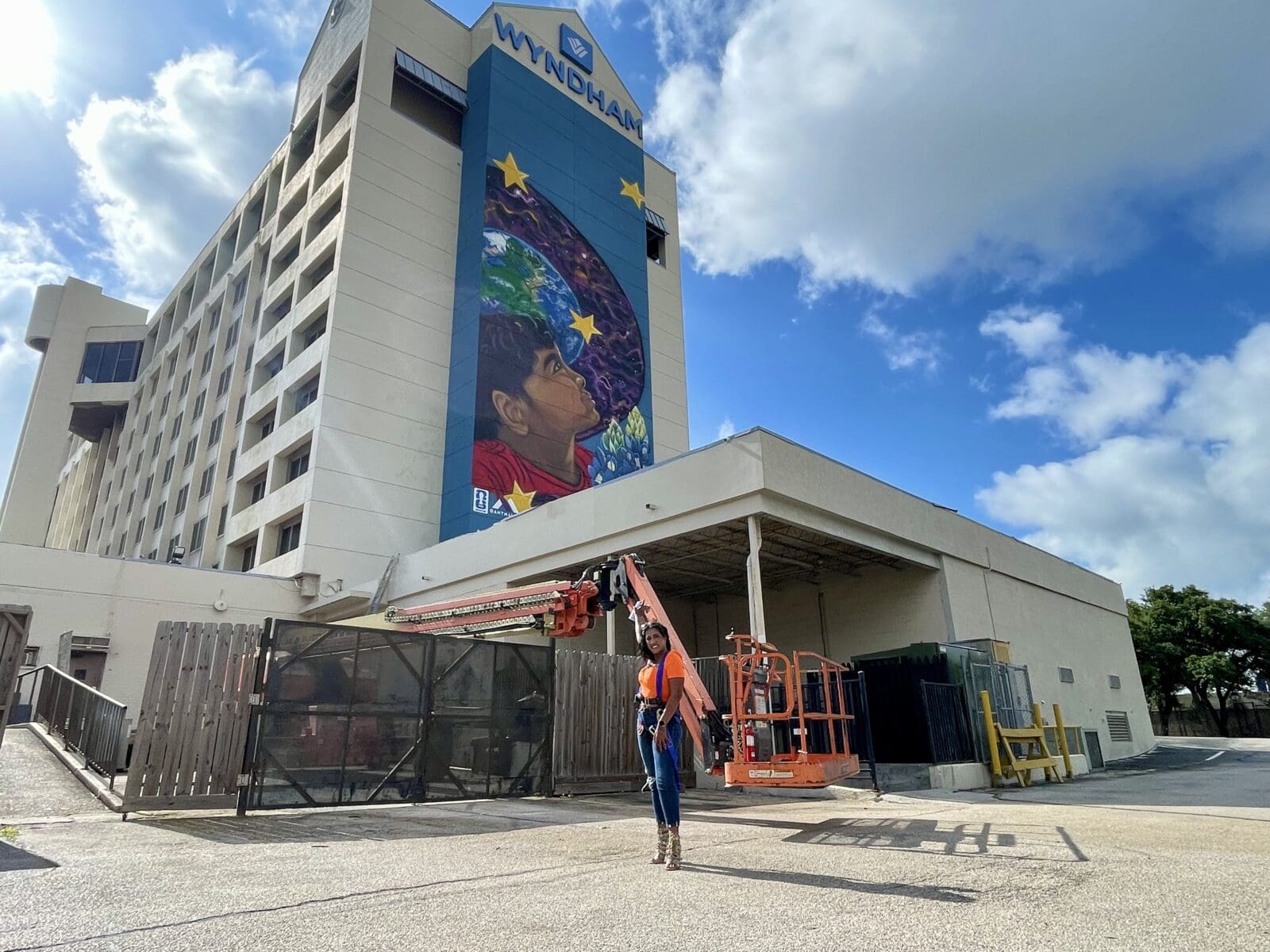 Artist Amy Malkan stands near her completed mural "Dream Big," 2026, painted in honor of FIFA World Cup 2026 in Houston. (Courtesy POP Studios PR, Houston)