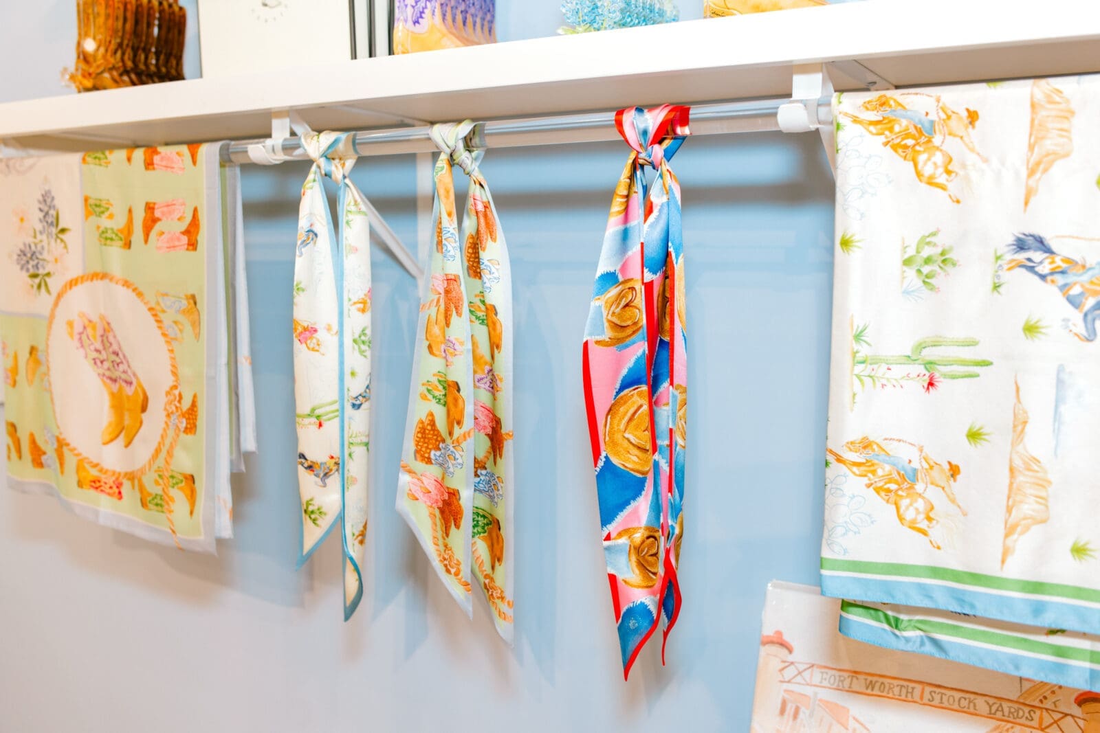 Cartie's watercolor artwork appears on a growing collection of silk scarves, many featuring Fort Worth and Western-inspired designs alongside colorful botanicals and wildlife. (Photo by Canon Sawyer)