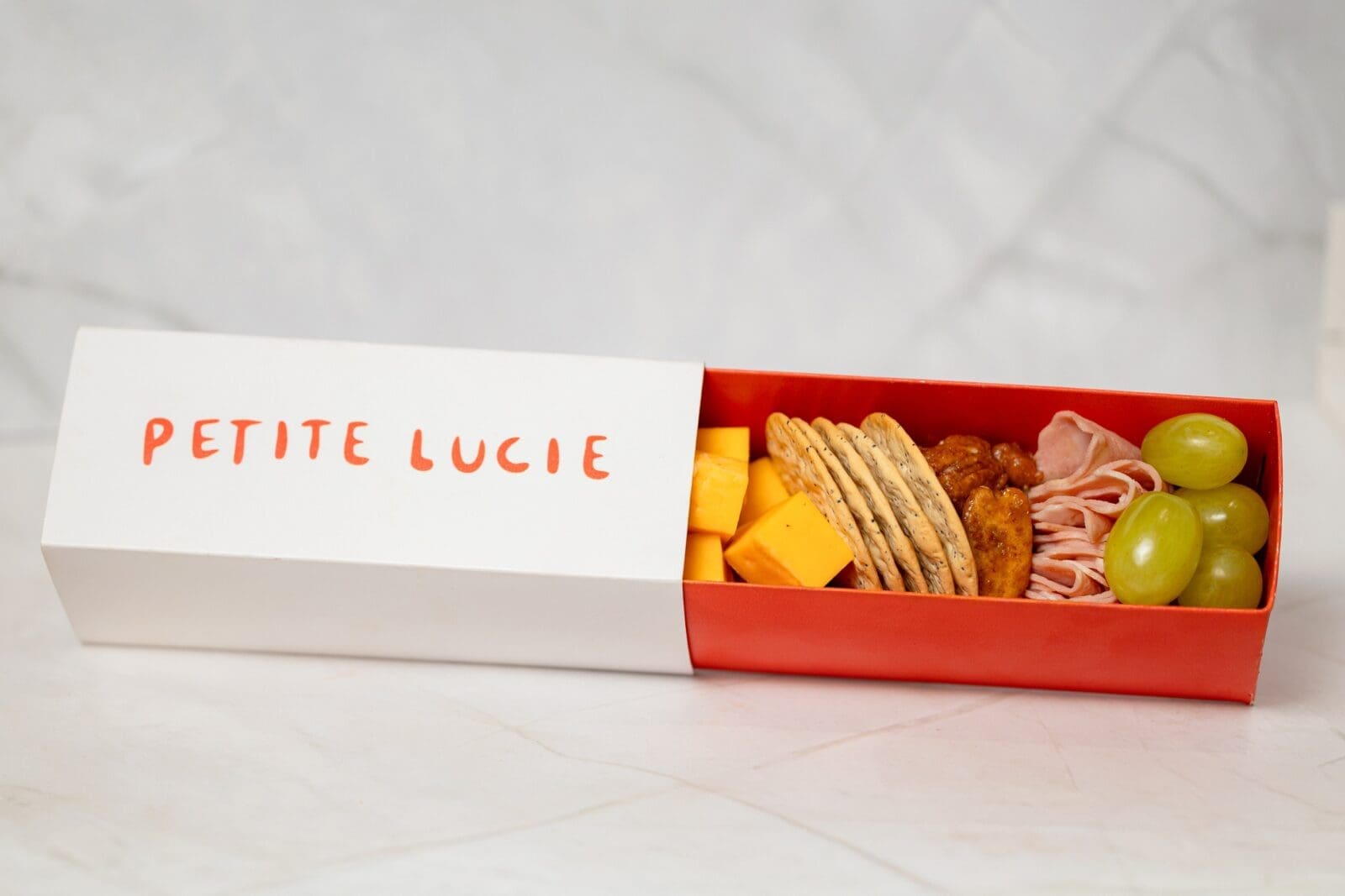 A compact charcuterie box ($8) is a great accoutrement to Petit Lucie's French-dominated wine list or house cocktails like the frozen St. Germain spritz.  (Photo by Mariela Callaway)