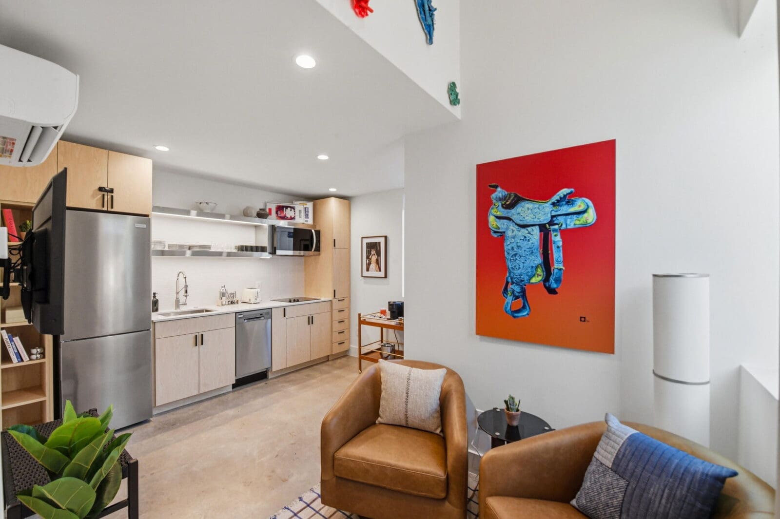 Inside a Hotel SOMA casita, soaring ceilings, full kitchens, cozy seating areas, and artwork sourced through William Campbell Contemporary create a stay that feels more like a stylish tiny home than a traditional hotel room. (Courtesy)