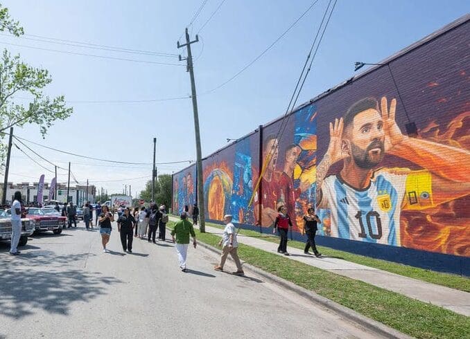 Attendees enjoy the unveiling of artist José "Meenr" Arredondo's "Welcome Mural," 2026, at the Original Ninfa's on Navigation. (Photo by Shane Dante. Courtesy Rachel Austin PR)