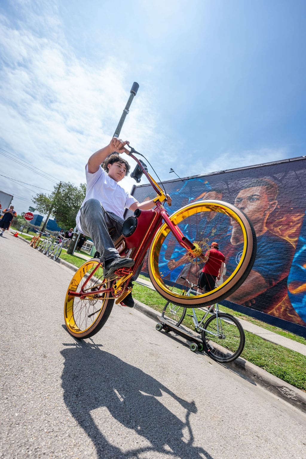 A biker rides near artist José "Meenr" Arredondo's "Welcome Mural," 2026, at the Original Ninfa's on Navigation. (Photo by Shane Dante. Courtesy Rachel Austin PR)