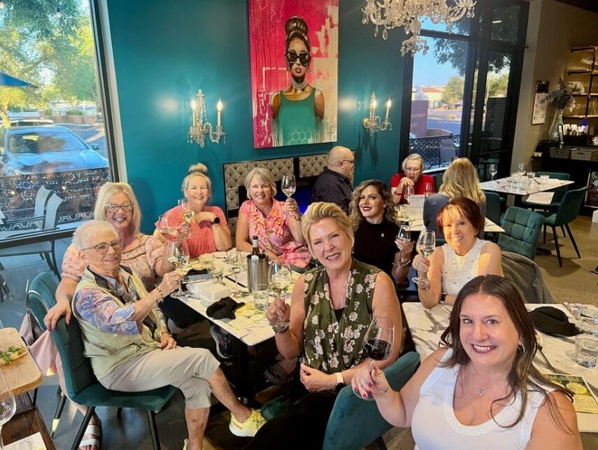 Diners raise a glass during a gathering at a Turquoise Wine Bar location. The Arizona-based wine bar is expected to open in The Woodlands this September. (Photo courtesy of Turquoise Wine Bar)