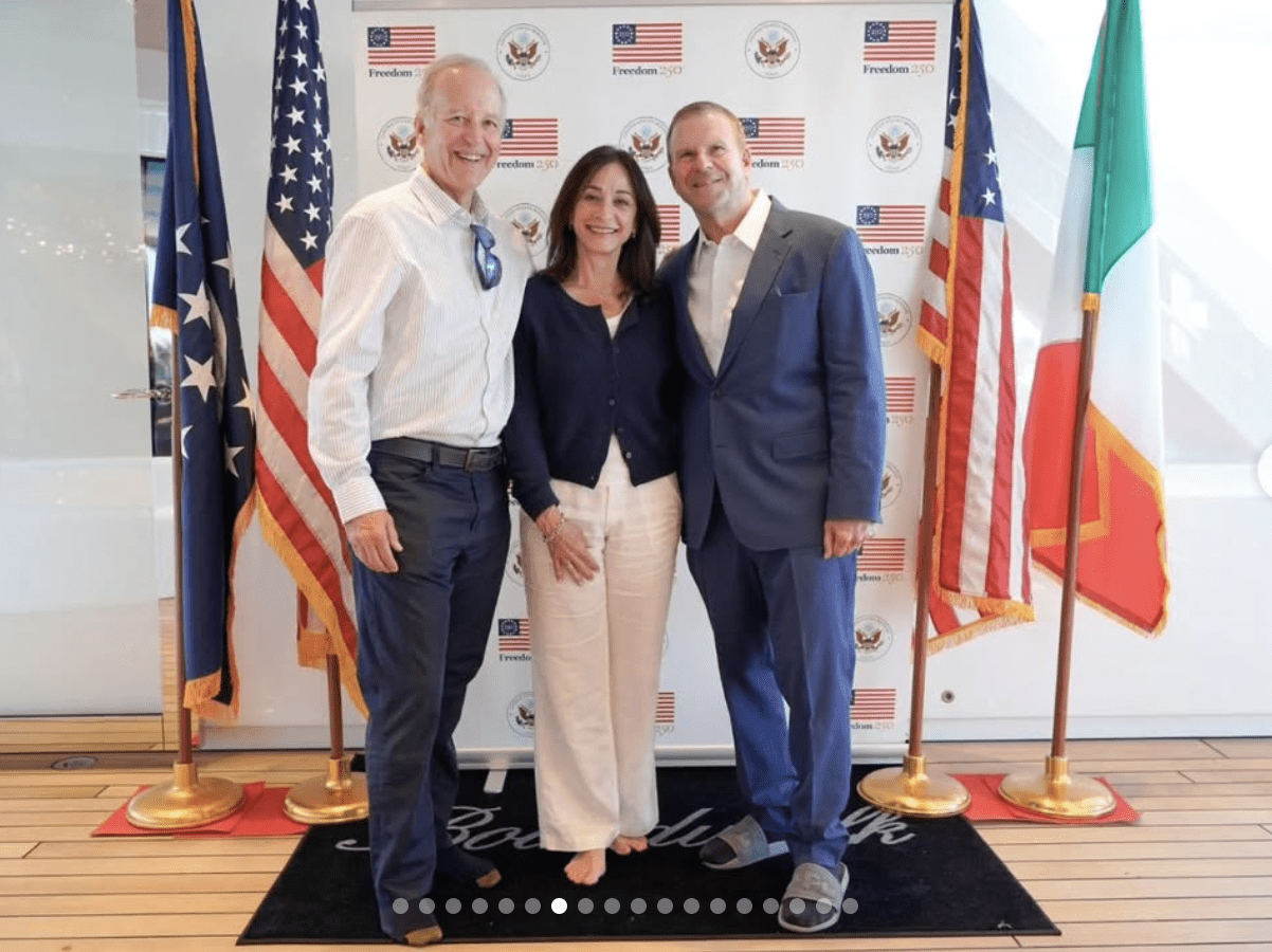 Ambassador Tilman Fertitta poses for photo ops aboard his super-yacht  Boardwalk. Note the bare feet and Fertitta's slippers — yachting requisite, no shoes. (Instagram photo)