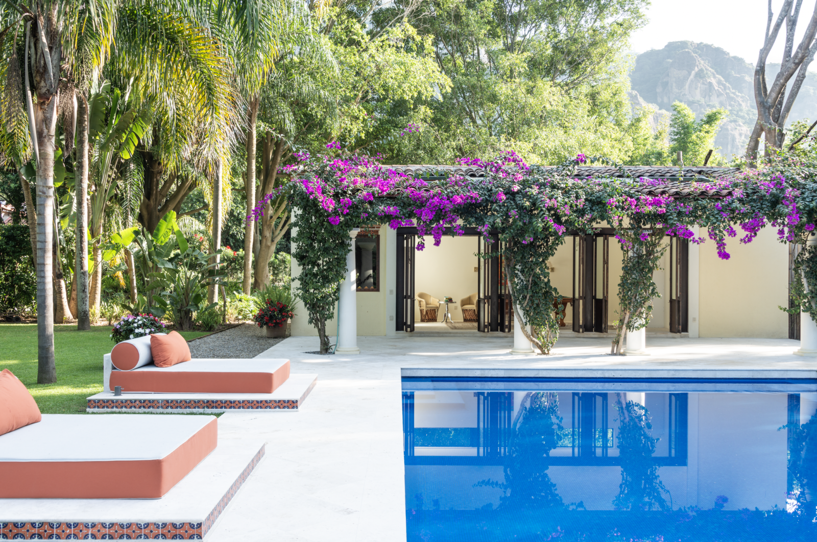 The pool house provides an al fresco dining area and two additional bedrooms. (Photo courtesy of Feronia)