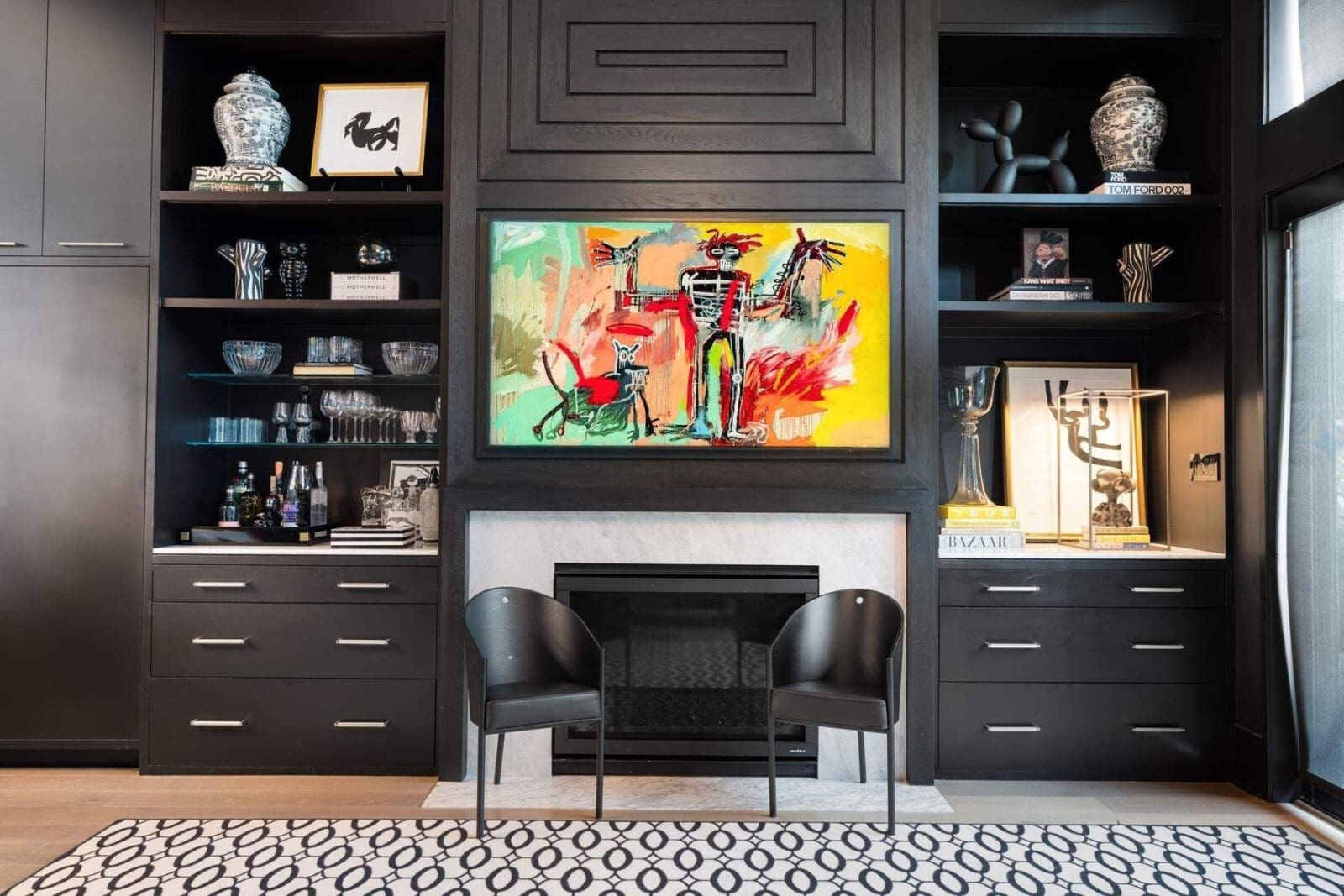 Custom millwork surrounds the fireplace with integrated storage and display, creating a tailored focal point that balances design and practicality.
 (Photo by Aria Media)