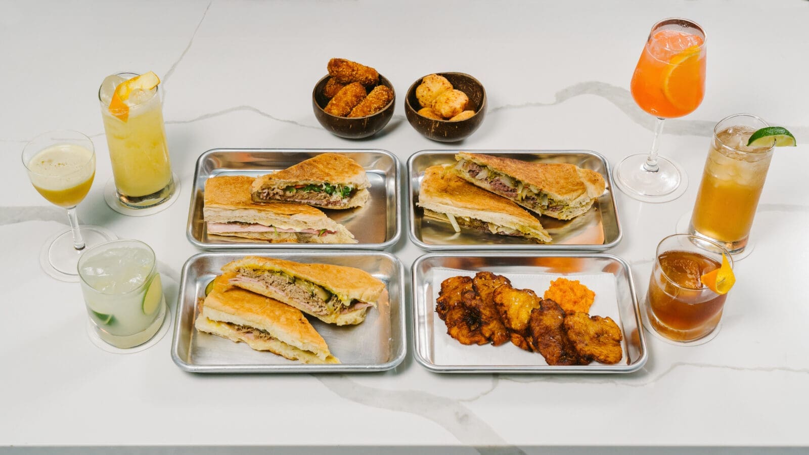 An array of Yuma's signature warm, pressed sandwiches, each of which is built on homemade Cuban-style bread. (Photo by Rebekah Flores)