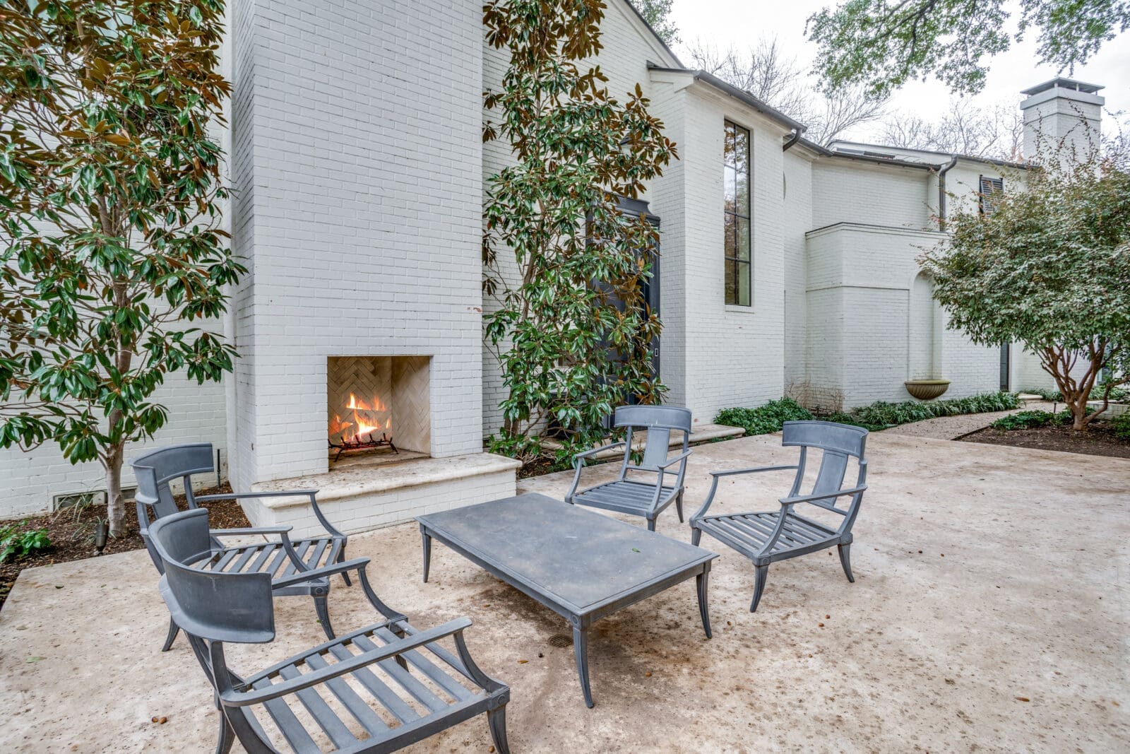 There is a patio with a fireplace near the front door. (Photo by Allie Beth Allman & Associates)
