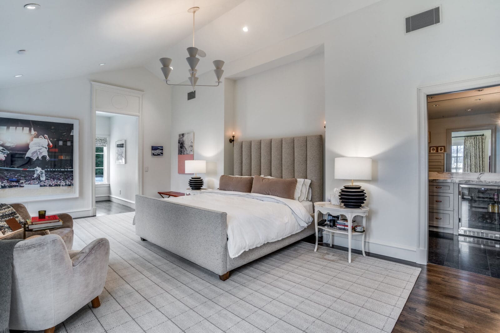 Vaulted ceilings flood the primary bedroom with natural light, and an attached balcony overlooks the creek. (Photo by Allie Beth Allman & Associates)