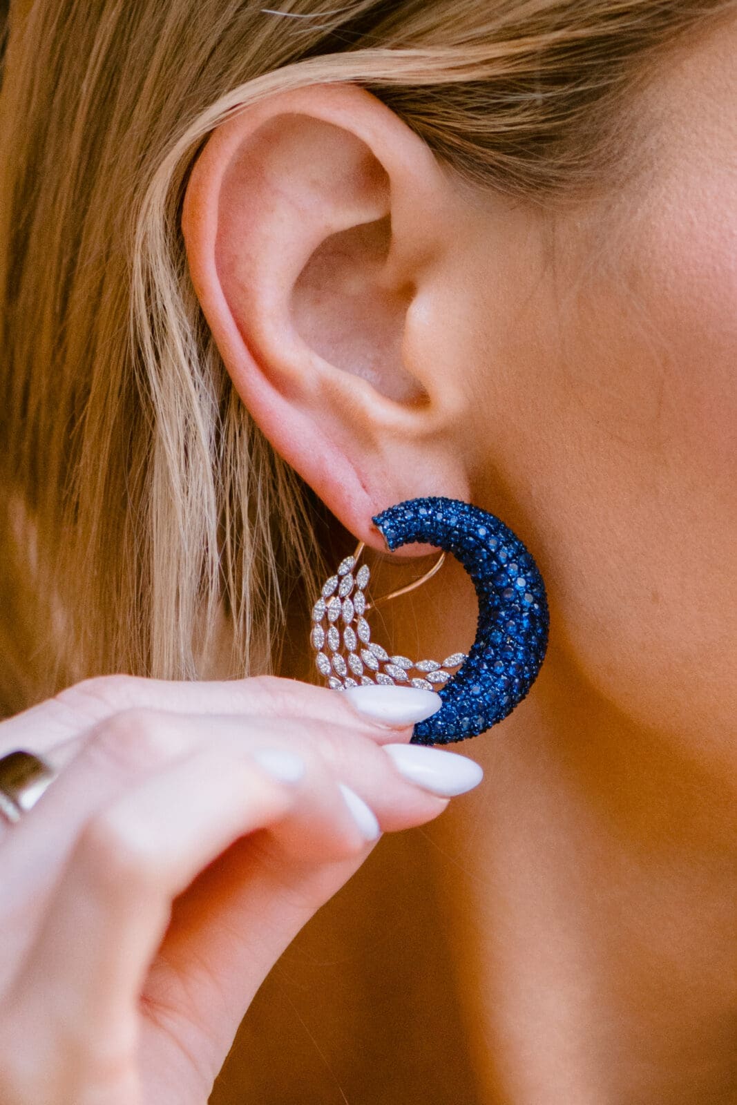 Fourteen karat rose gold peacock-inspired studs from SĀMAÁ Diamonds worn by Danielle Dubois (Photo by Si Vo Photography)
