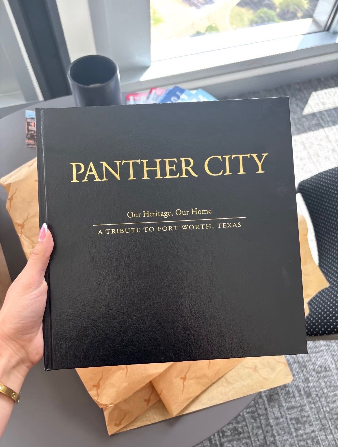 A copy of Panther City: Our Heritage, Our Home was presented to Princess Takamado by the City of Fort Worth. (Photograph by Brooks Burris for Visit Fort Worth)