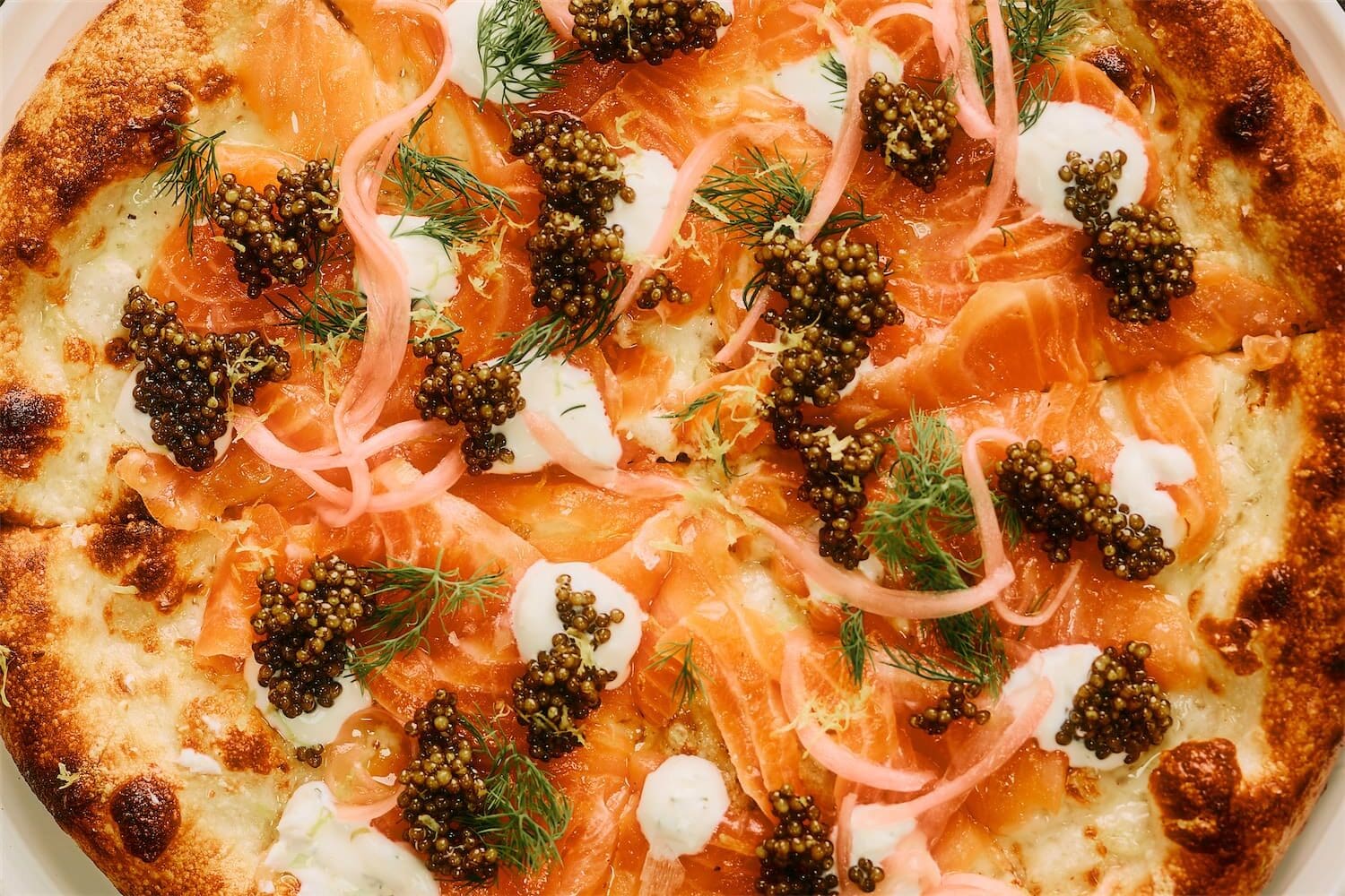 The pizzas are a favorite at Scilla. Splurge with the $80 Ossetra Caviar Pizza. (Photo by Chase Hall)