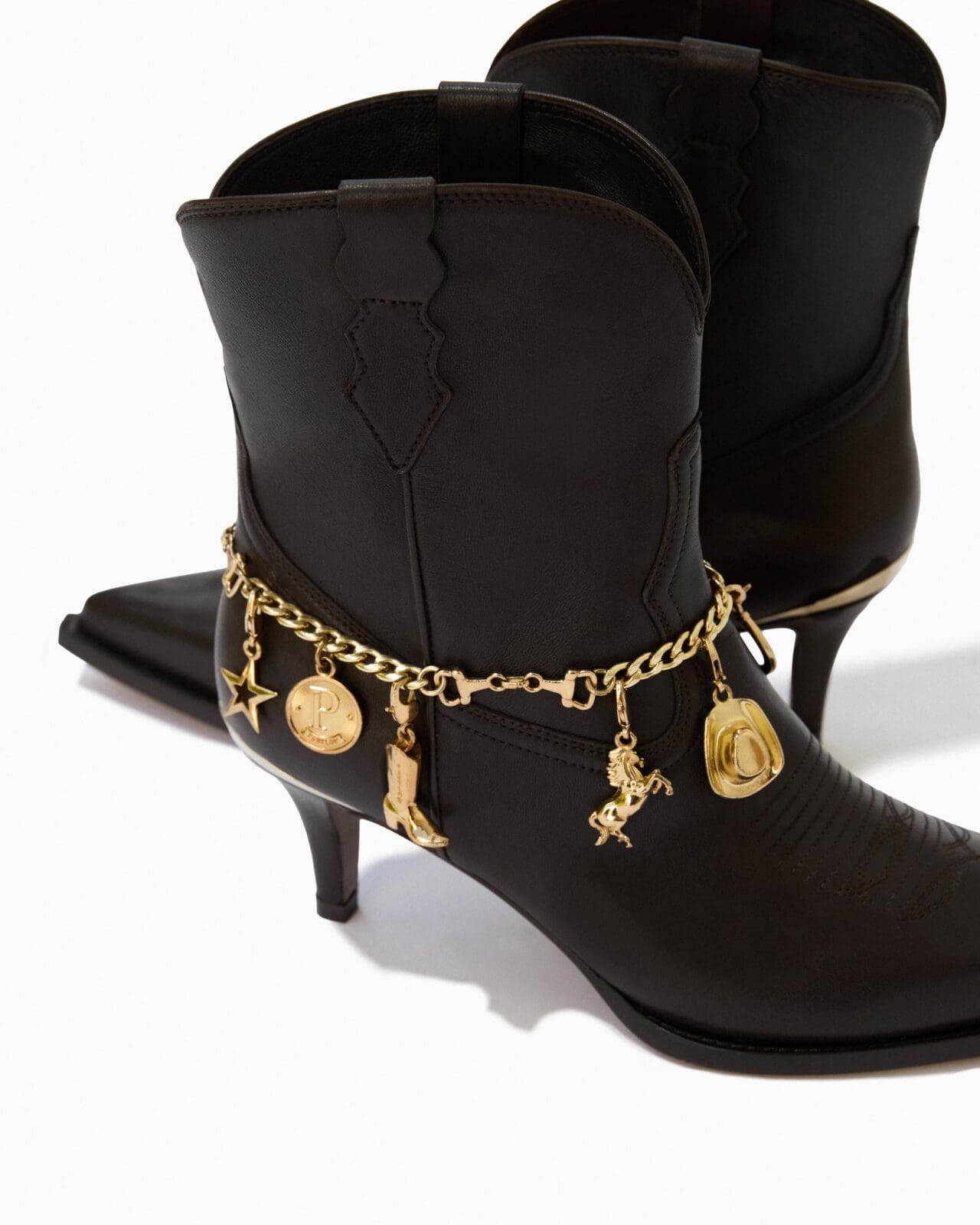 Gold tone charms encircle the Partlow boot for an enhanced look of sophistication.